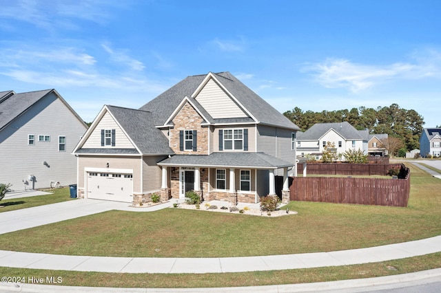 craftsman house featuring a front yard and a garage