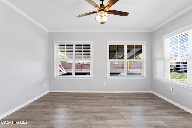 empty room featuring ceiling fan, hardwood / wood-style floors, and ornamental molding