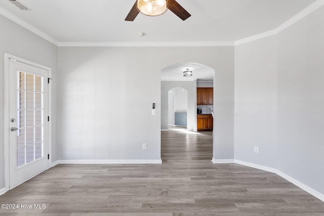 spare room featuring light hardwood / wood-style flooring, ceiling fan, and ornamental molding