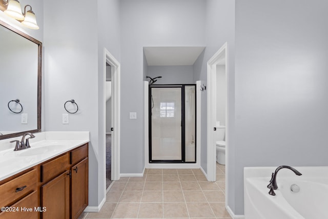 full bathroom with tile patterned floors, vanity, toilet, and independent shower and bath