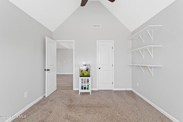 interior space featuring carpet, ceiling fan, and high vaulted ceiling