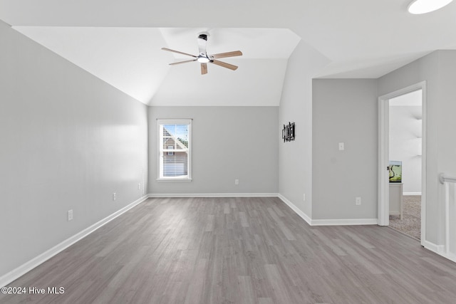 interior space with ceiling fan, light hardwood / wood-style floors, and vaulted ceiling