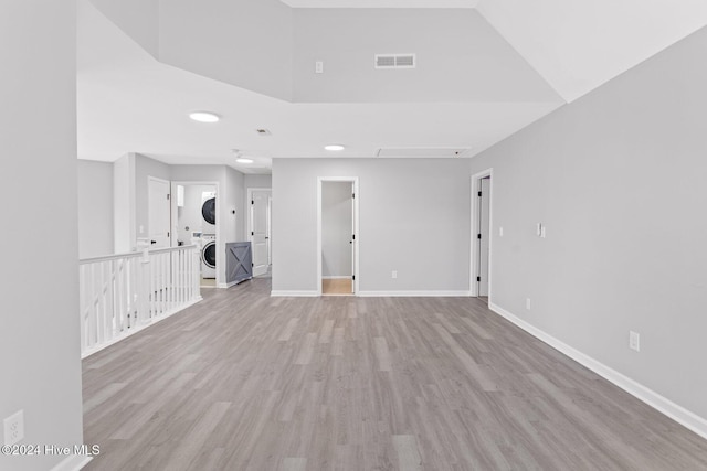 102 Hills Lorough Loop, Jacksonville, NC 28546 - unfurnished room with stacked washer / drying machine, light wood-type flooring, and baseboards
