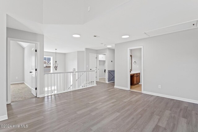 102 Hills Lorough Loop, Jacksonville, NC 28546 - unfurnished room with light wood-type flooring, attic access, and baseboards