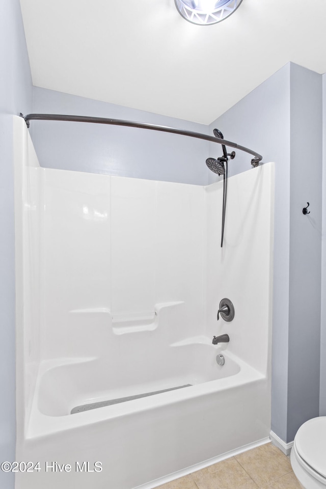 bathroom featuring tile patterned floors, shower / bath combination, and toilet