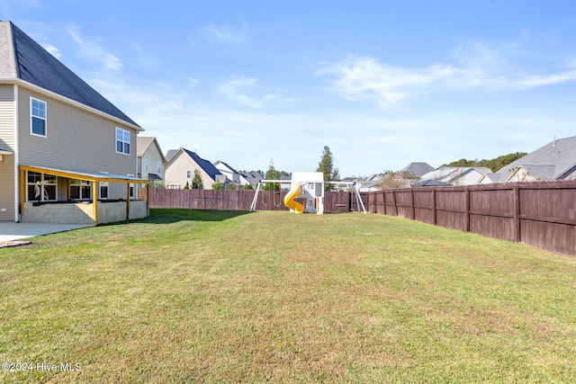 view of yard featuring a patio and a playground