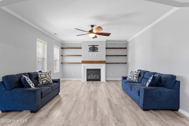 living room with light hardwood / wood-style floors, ceiling fan, and crown molding