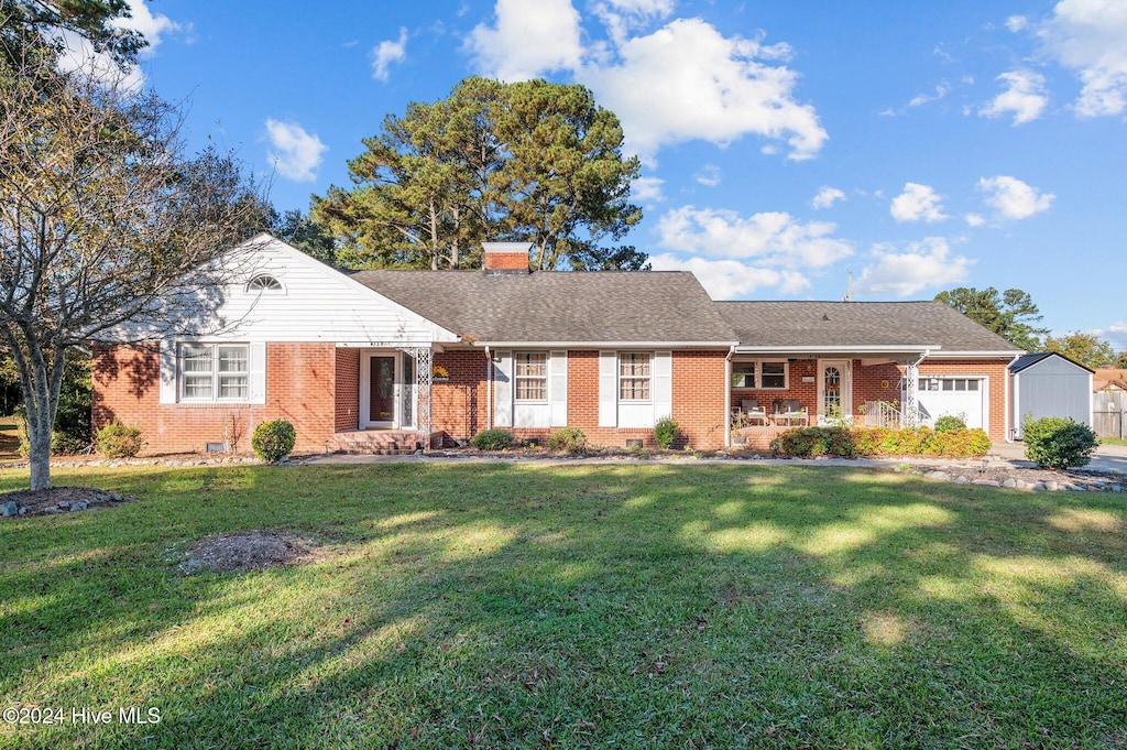 ranch-style house with a front yard and a garage