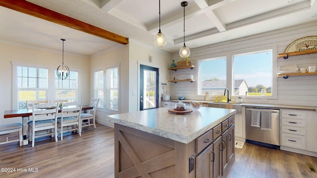 kitchen with wood walls, decorative light fixtures, dark hardwood / wood-style floors, and a center island