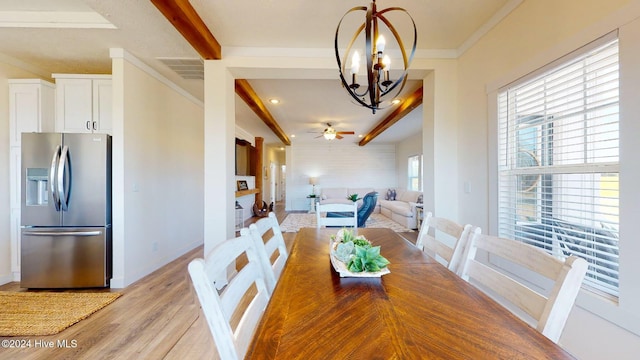 dining space featuring light hardwood / wood-style floors, ceiling fan with notable chandelier, beam ceiling, and crown molding