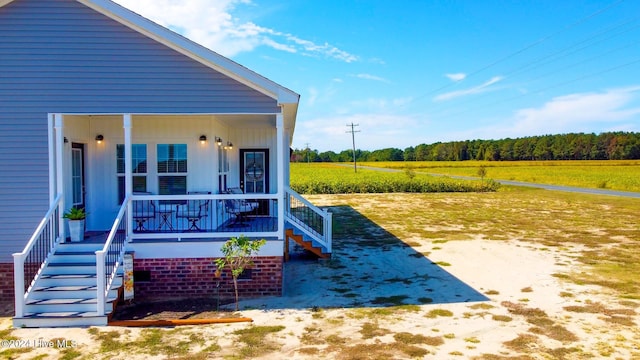 exterior space featuring a rural view and a porch