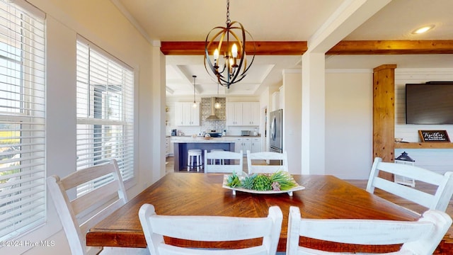 dining space with a chandelier and beam ceiling