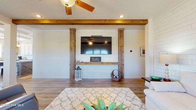 living room with ceiling fan, beam ceiling, and dark hardwood / wood-style flooring