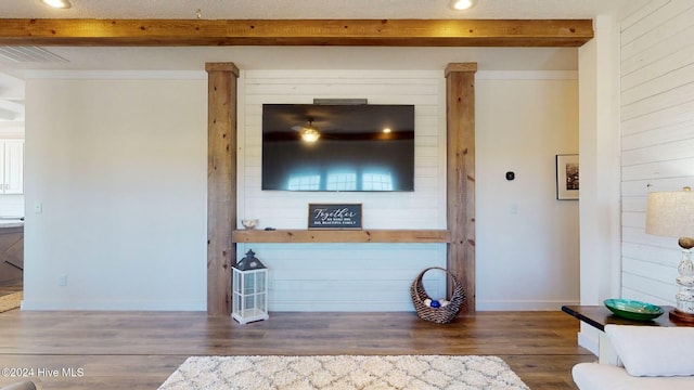 unfurnished living room with dark hardwood / wood-style flooring and beam ceiling