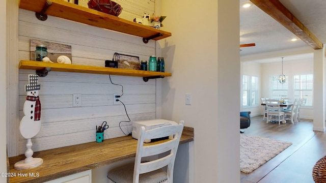 mudroom featuring beamed ceiling, wood-type flooring, and a notable chandelier