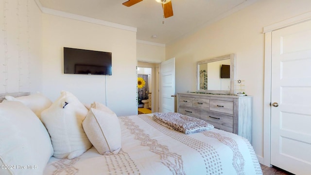 bedroom with hardwood / wood-style flooring, ceiling fan, and crown molding