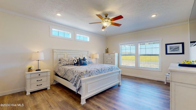 bedroom featuring dark wood-type flooring, ornamental molding, a textured ceiling, and ceiling fan