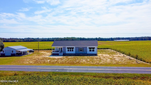 exterior space featuring covered porch and a rural view