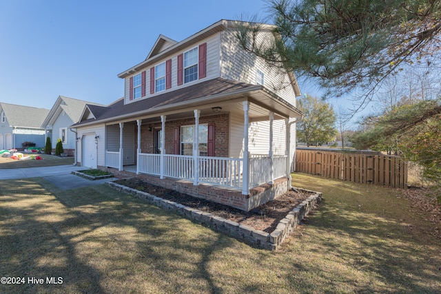 view of front facade with a porch, a garage, and a front yard