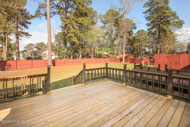 wooden terrace featuring a yard