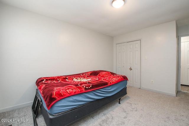 carpeted bedroom featuring a closet