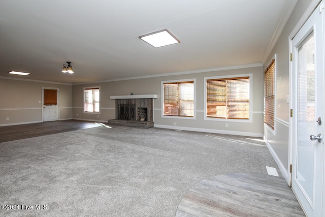 unfurnished living room featuring carpet floors and ornamental molding