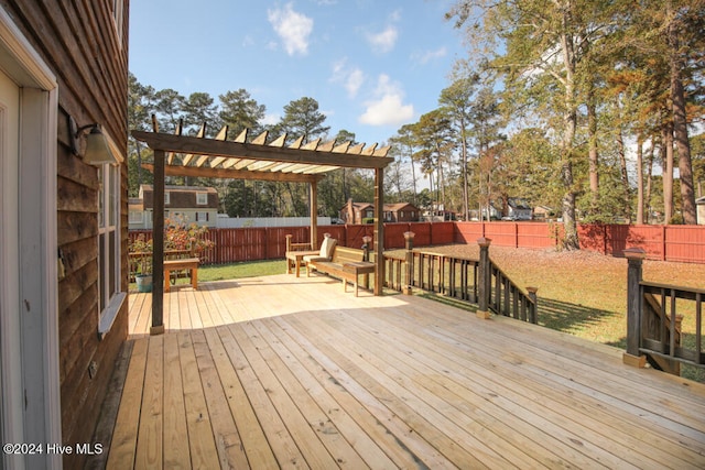 wooden terrace featuring a lawn and a pergola