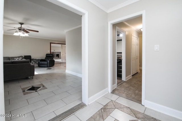 corridor featuring crown molding and light tile patterned floors