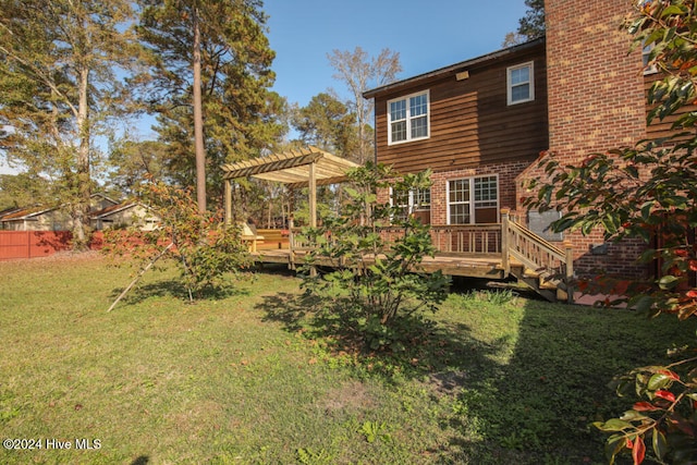 view of yard with a pergola and a deck