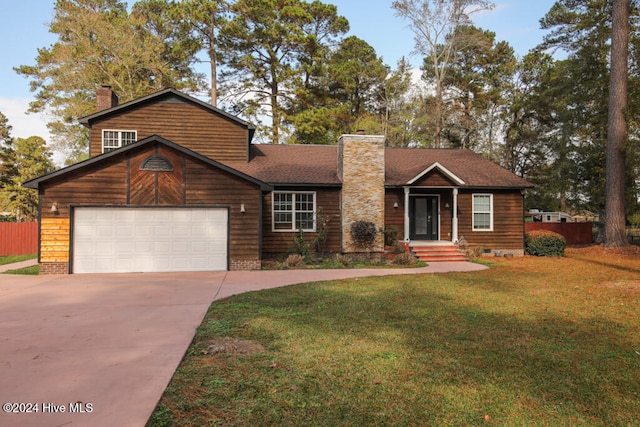 view of front of home with a front yard and a garage