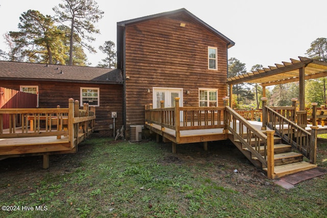 back of property featuring a pergola, a deck, central AC unit, and a lawn