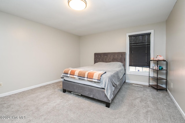 bedroom featuring light colored carpet