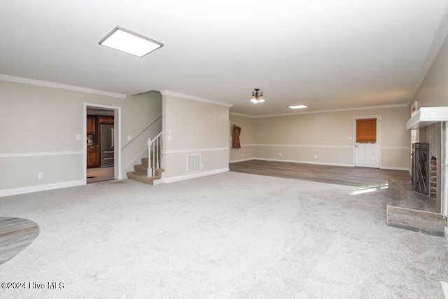 unfurnished living room with carpet floors and ornamental molding