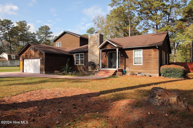 view of front of house with a front lawn and a garage