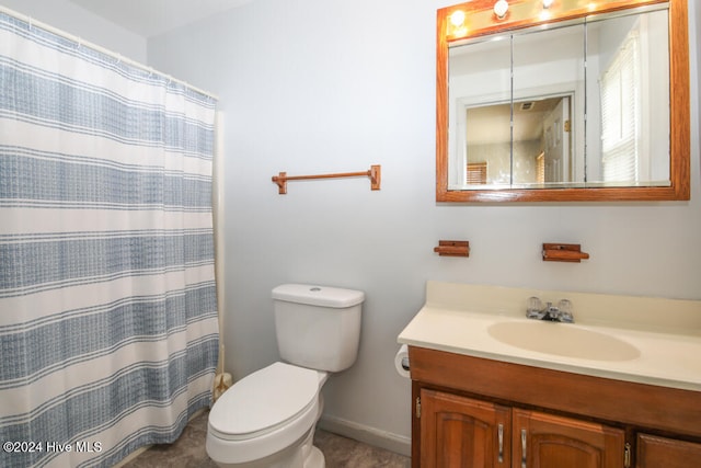 bathroom featuring vanity, curtained shower, and toilet