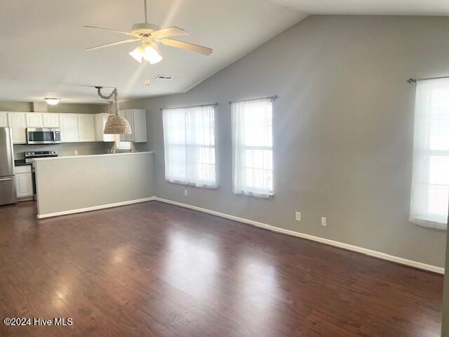 interior space featuring dark wood-type flooring, lofted ceiling, and ceiling fan