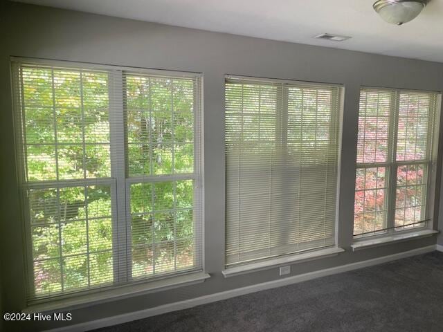 doorway to outside featuring carpet floors