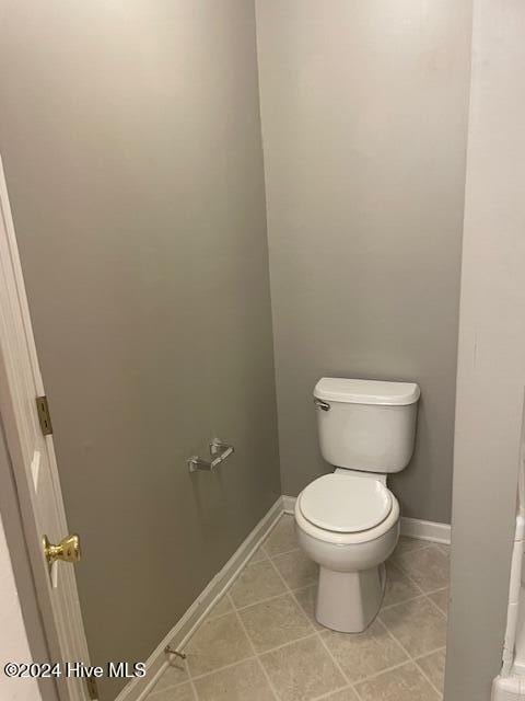 bathroom featuring tile patterned flooring and toilet