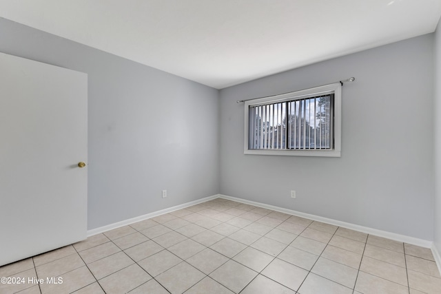 spare room featuring light tile patterned flooring