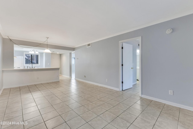 unfurnished room featuring a chandelier, sink, light tile patterned flooring, and crown molding