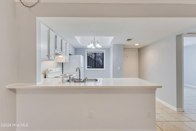 kitchen with kitchen peninsula, white appliances, a notable chandelier, and light tile patterned flooring