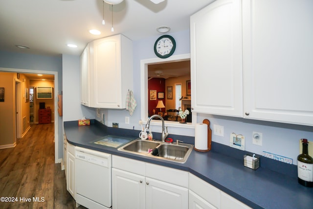 kitchen featuring white dishwasher, ceiling fan, dark wood-type flooring, sink, and white cabinets