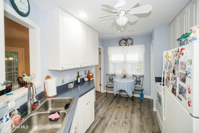 kitchen featuring white appliances, white cabinets, sink, ceiling fan, and light hardwood / wood-style floors