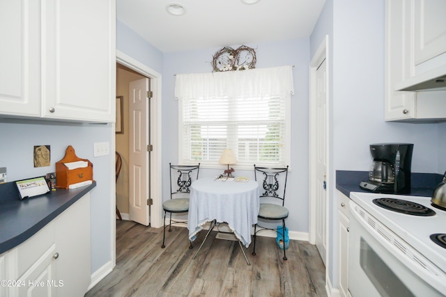 kitchen with white cabinetry, light wood-type flooring, and white electric range oven