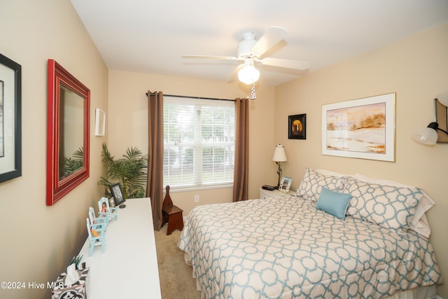 bedroom with ceiling fan and light colored carpet