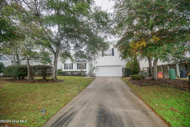 view of front of home with a garage and a front lawn