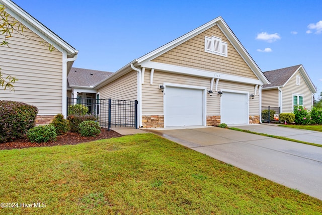 view of front of property with a garage and a front yard