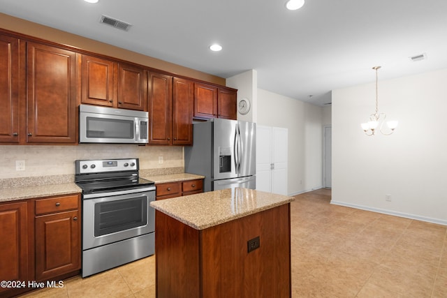 kitchen with a center island, decorative backsplash, hanging light fixtures, a notable chandelier, and appliances with stainless steel finishes