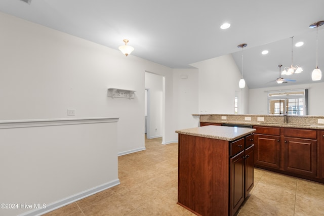 kitchen featuring sink, ceiling fan, lofted ceiling, a center island, and pendant lighting