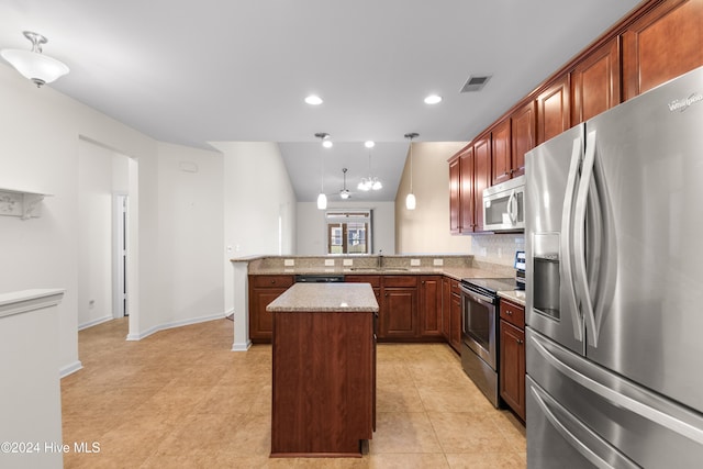 kitchen featuring decorative backsplash, kitchen peninsula, appliances with stainless steel finishes, a center island, and vaulted ceiling